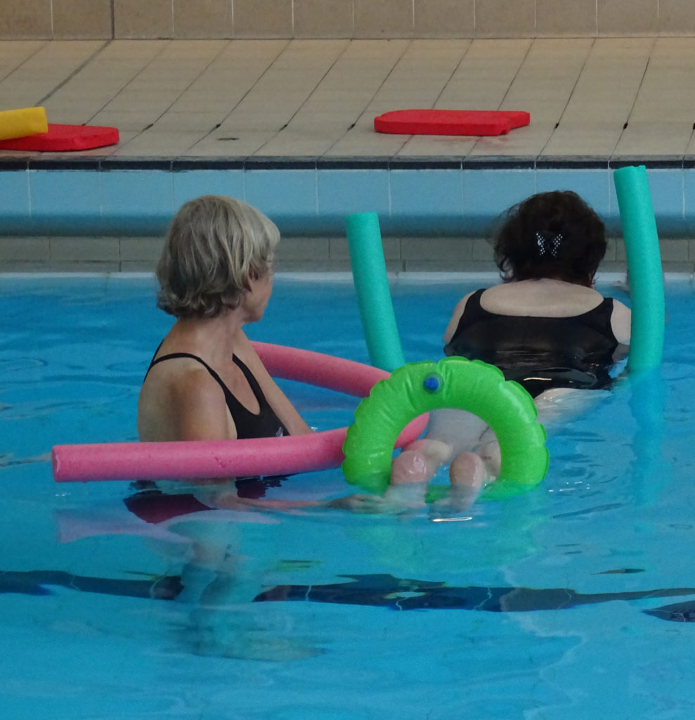 Stretching back muscles by holding onto side floating horizontal on floats